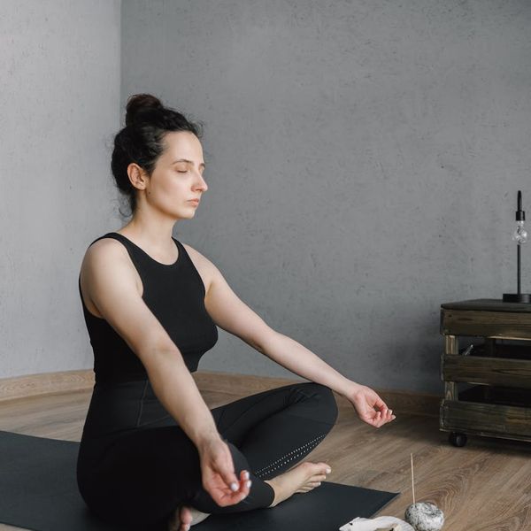 A calm and tidy corner of a room set up for home yoga practice.